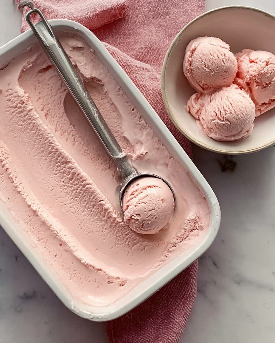 A white rectangular dish is filled with smooth, light pink ice cream that has a soft, creamy texture with visible scoop marks and slight ridges on the surface. Next to the dish, there is a white bowl holding four perfect scoops of the same light pink ice cream, showing a slightly bumpy texture typical of frozen desserts. A metal ice cream scooper with some ice cream still inside rests on the edge of the rectangular dish. The background is a white marbled surface and there is a woman's hand gently holding the scooper. photo taken with an iphone --ar 4:5 --v 7