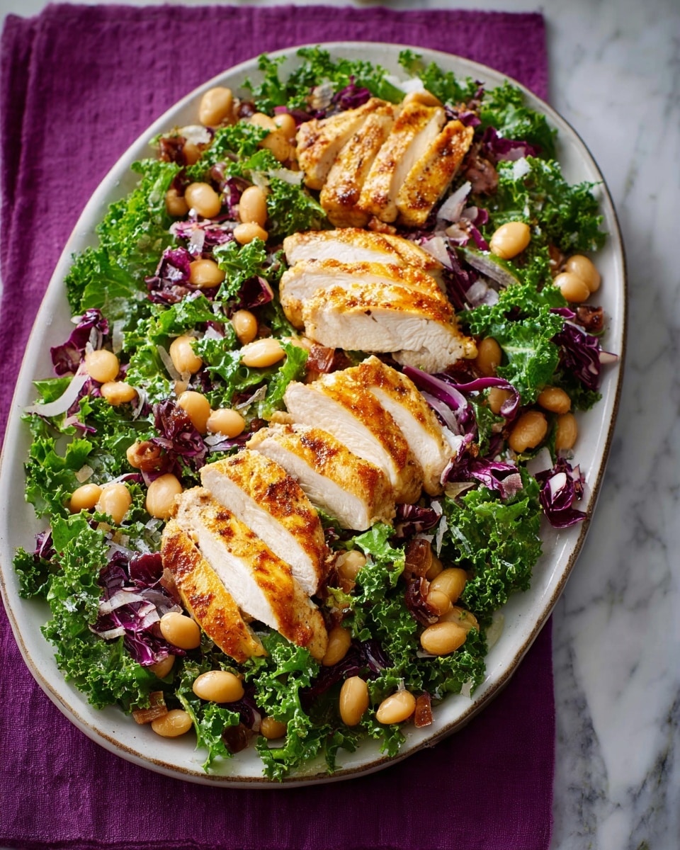 The dish shows two rows of thick, golden brown grilled chicken breast slices placed on top of a bed of mixed leafy greens including dark green kale and purple radicchio. Scattered around the chicken and greens are tan-colored bean pods and a few roasted garlic cloves, adding texture and color contrast. The food is served on an oval white plate with speckled edges, set against a white marbled surface with a purple cloth partially underneath. The overall look is fresh and colorful with warm tones from the chicken and beans. photo taken with an iphone --ar 4:5 --v 7