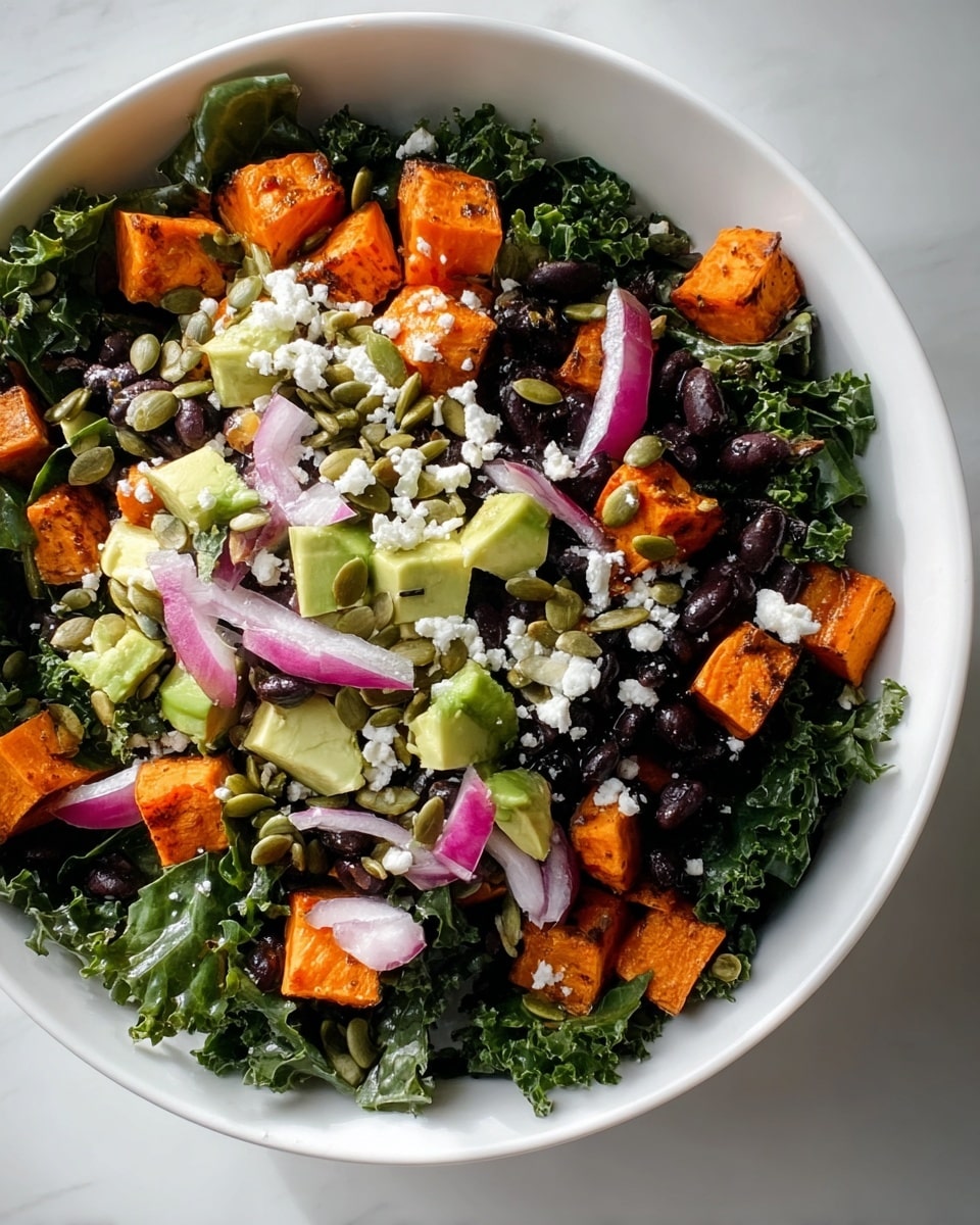A white bowl holds a colorful salad arranged in layers, starting with a bed of dark green, curly kale leaves as the base. On top, there are bright orange cubes of roasted sweet potato scattered evenly, followed by chunks of light green avocado. Thin slices of purple-red onion add a soft contrast, along with small black beans spread across the salad. The dish is sprinkled generously with white crumbled cheese and light green pumpkin seeds, giving it a mixed texture of smooth, crunchy, and soft elements. The salad is placed on a white marbled surface with natural light highlighting the fresh, vibrant colors. photo taken with an iphone --ar 4:5 --v 7