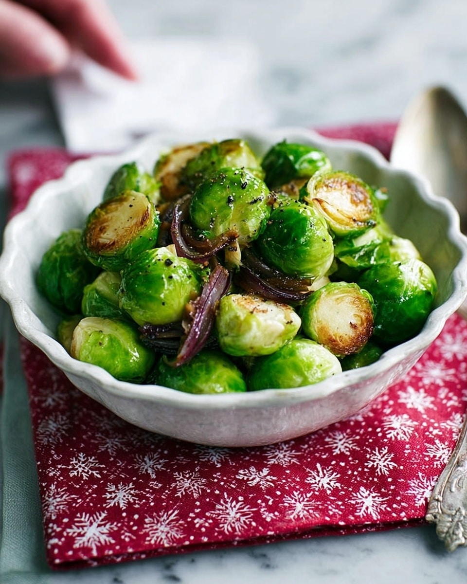 A white, round dish filled with bright green Brussels sprouts mixed with pieces of soft purple-red onion. The Brussels sprouts are whole, shiny, and smooth, with a fresh green color. The onion slices are slightly caramelized with a tender texture, scattered evenly among the sprouts. The dish is placed on a red and white patterned cloth on a white marbled surface. A blurred spoon and a glass jar are visible in the background. Photo taken with an iphone --ar 4:5 --v 7