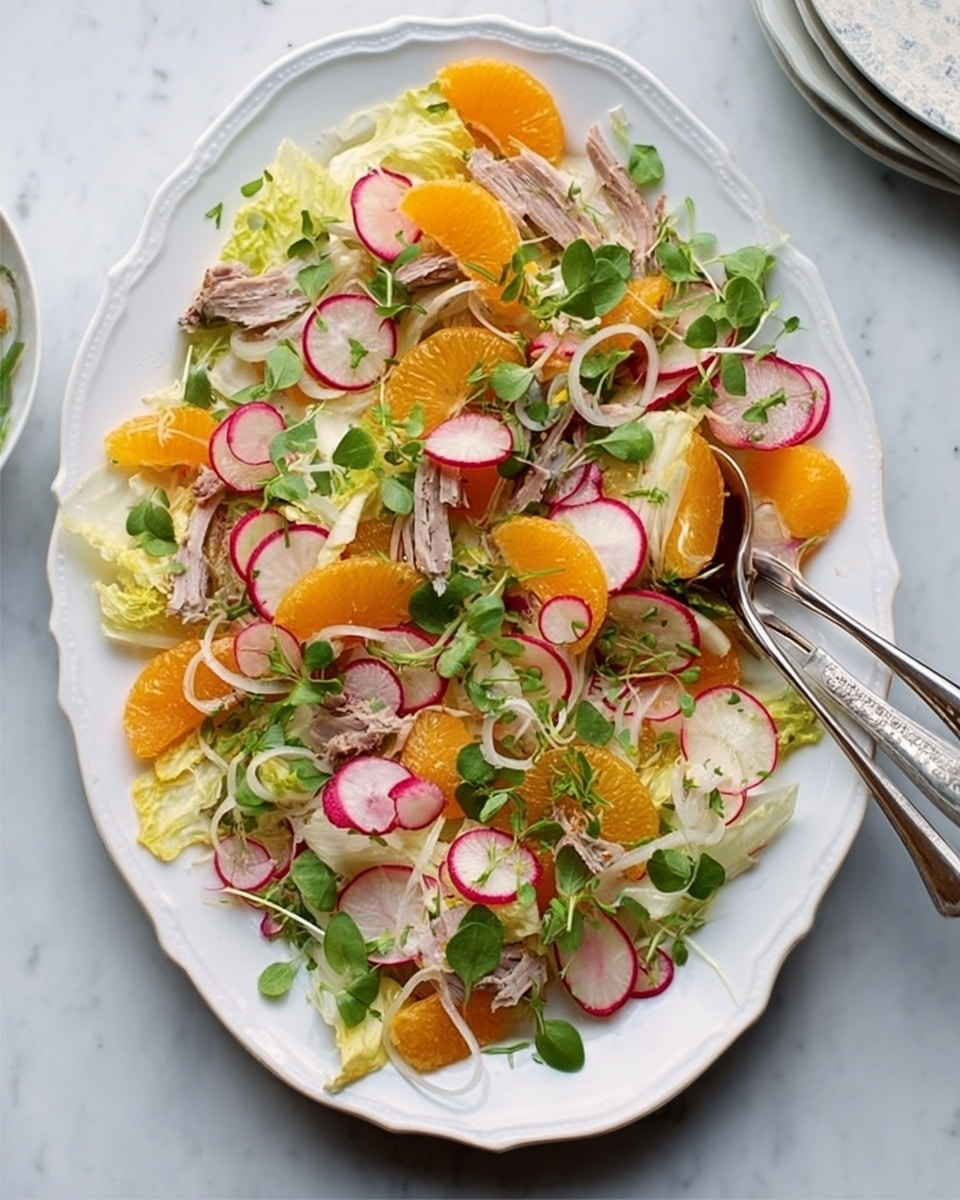 The image shows a white oval plate filled with a fresh salad on a white marbled surface. The salad has several layers, starting with a base of light green endive leaves spread evenly. On top of the base, thin slices of round red radishes add a pop of color and a crisp texture. Bright orange citrus segments are scattered evenly, adding a juicy look. There are shredded pieces of light brown cooked meat placed in small piles across the plate. Small green leafy sprigs are sprinkled generously over the whole salad, giving it a fresh and lively appearance. A pair of silver serving spoons is placed on top of the salad near one edge of the plate. Photo taken with an iphone --ar 4:5 --v 7